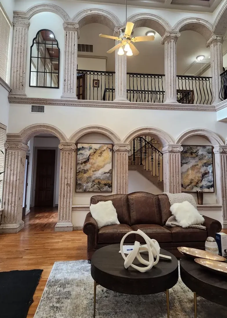 Cantera columns and arches in a two-storey living room