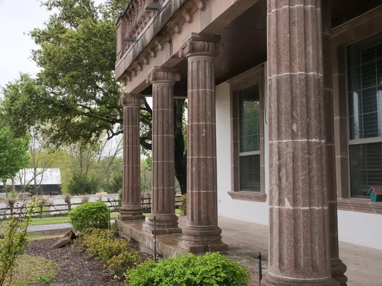 Fluted stone columns on a residential porch