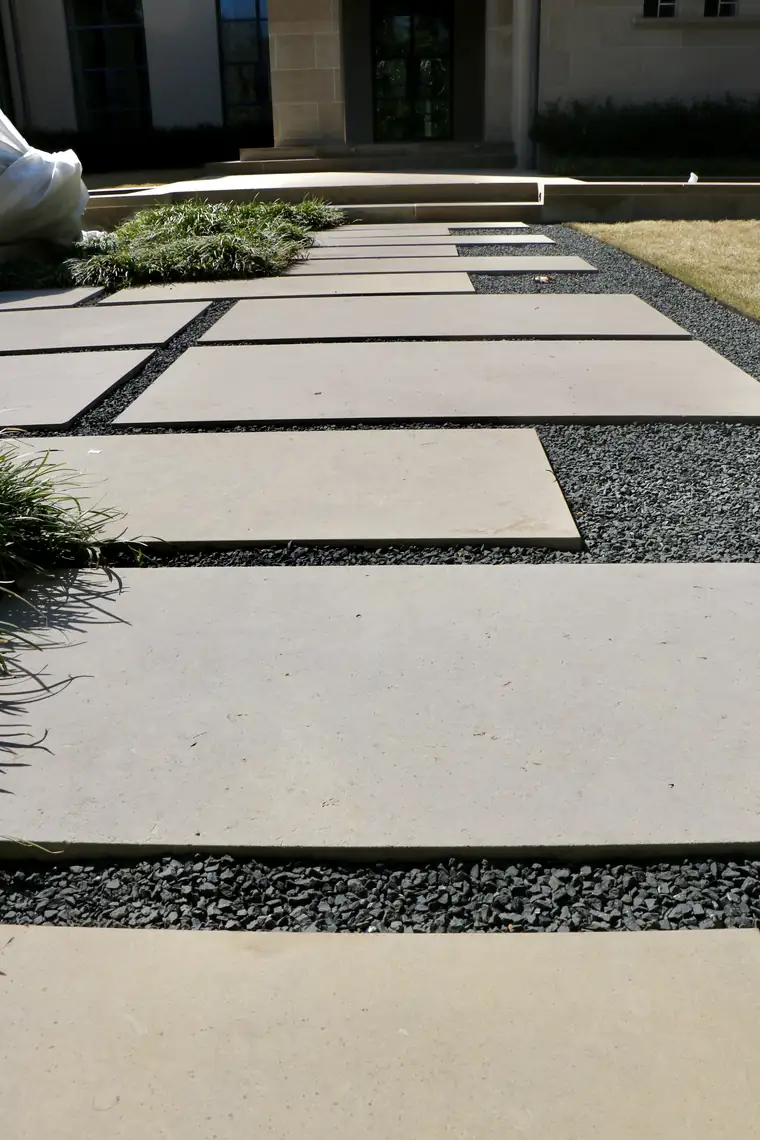 Large-format limestone pavers set in gravel